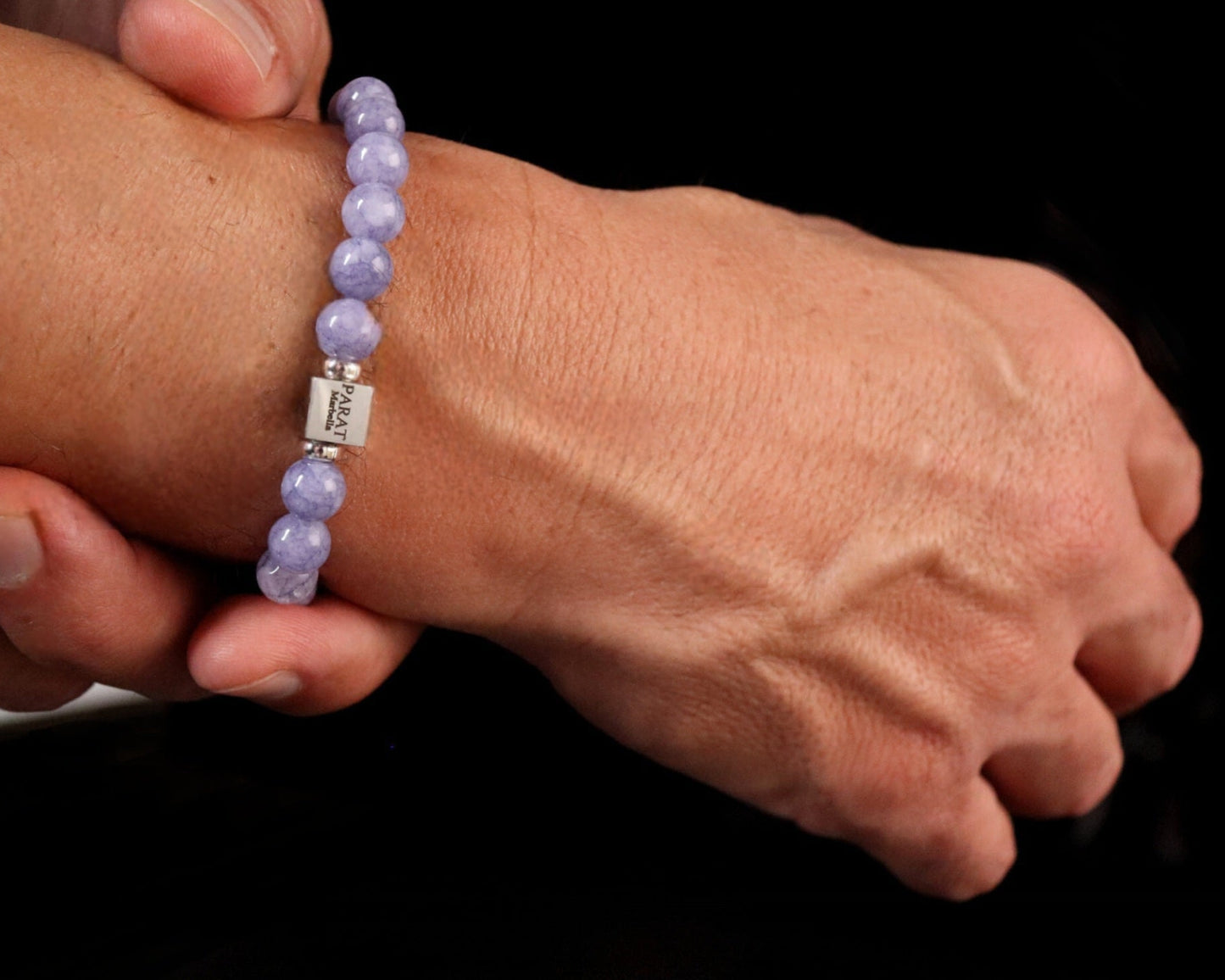 Angelite bracelet worn on wrist - lifestyle spiritual jewelry men