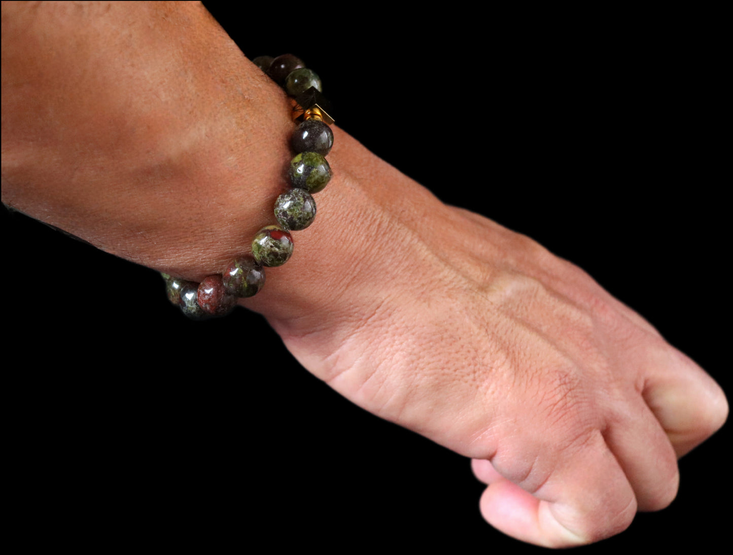 Bloodstone 8mm bracelet 14K gold worn on wrist - warrior stone lifestyle jewelry men