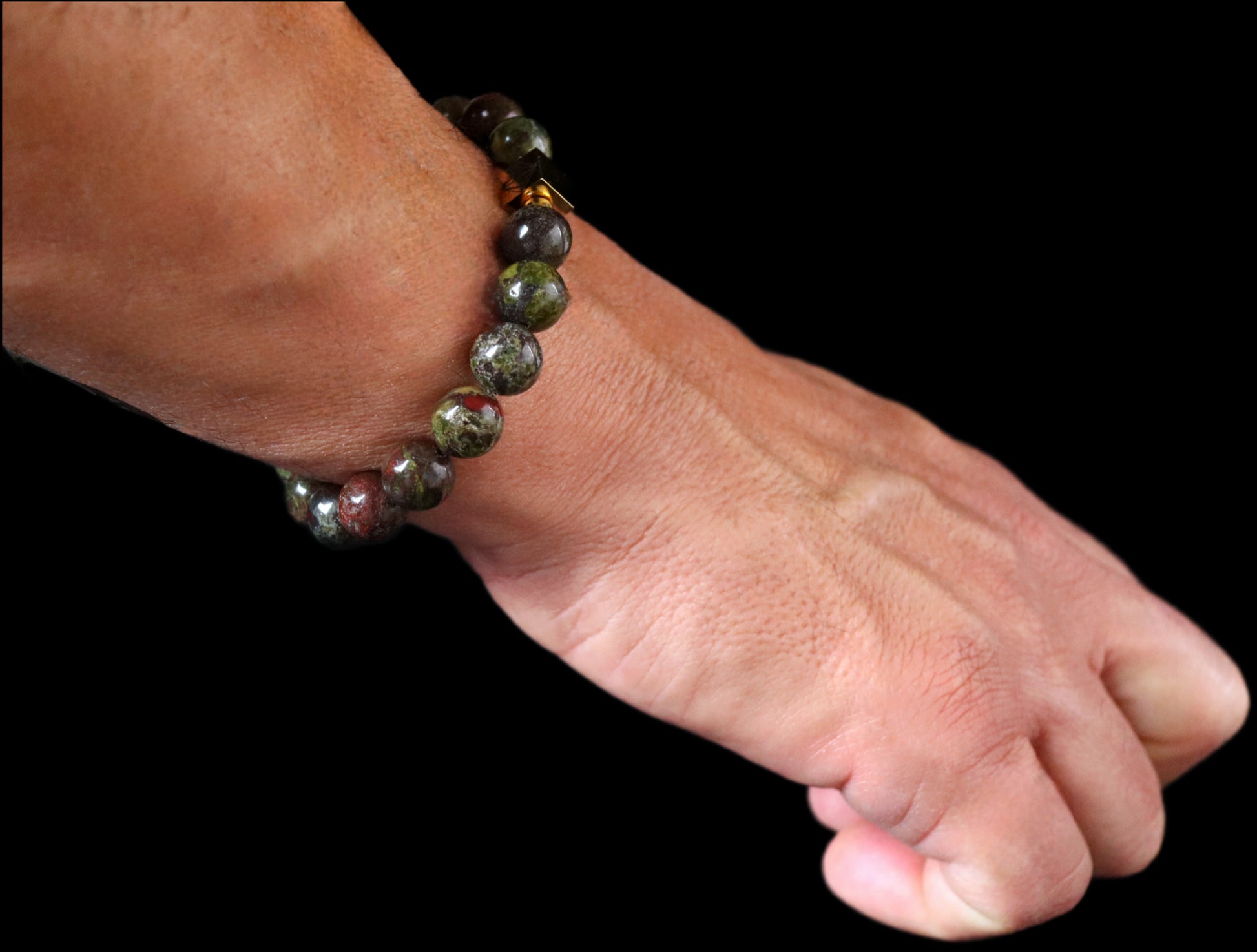 Bloodstone 8mm bracelet 14K gold worn on wrist - warrior stone lifestyle jewelry men