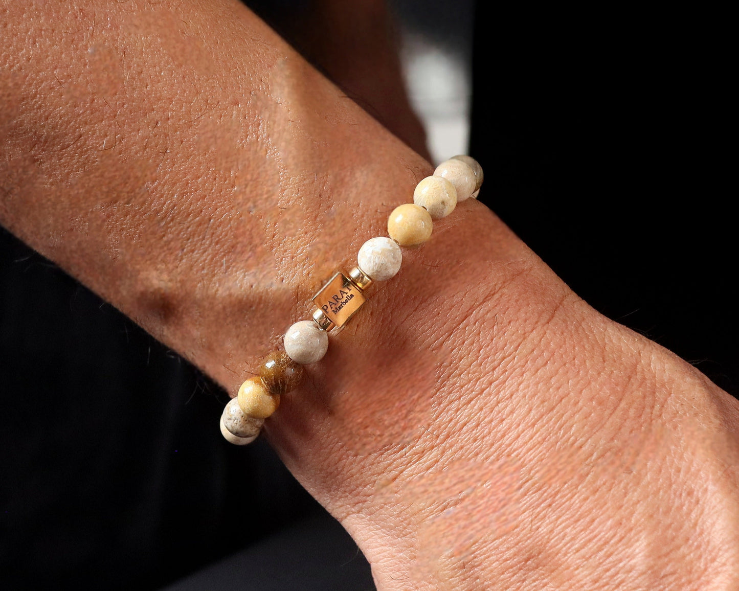 Fossilized Coral bracelet worn on wrist - lifestyle ancient fossil jewelry men