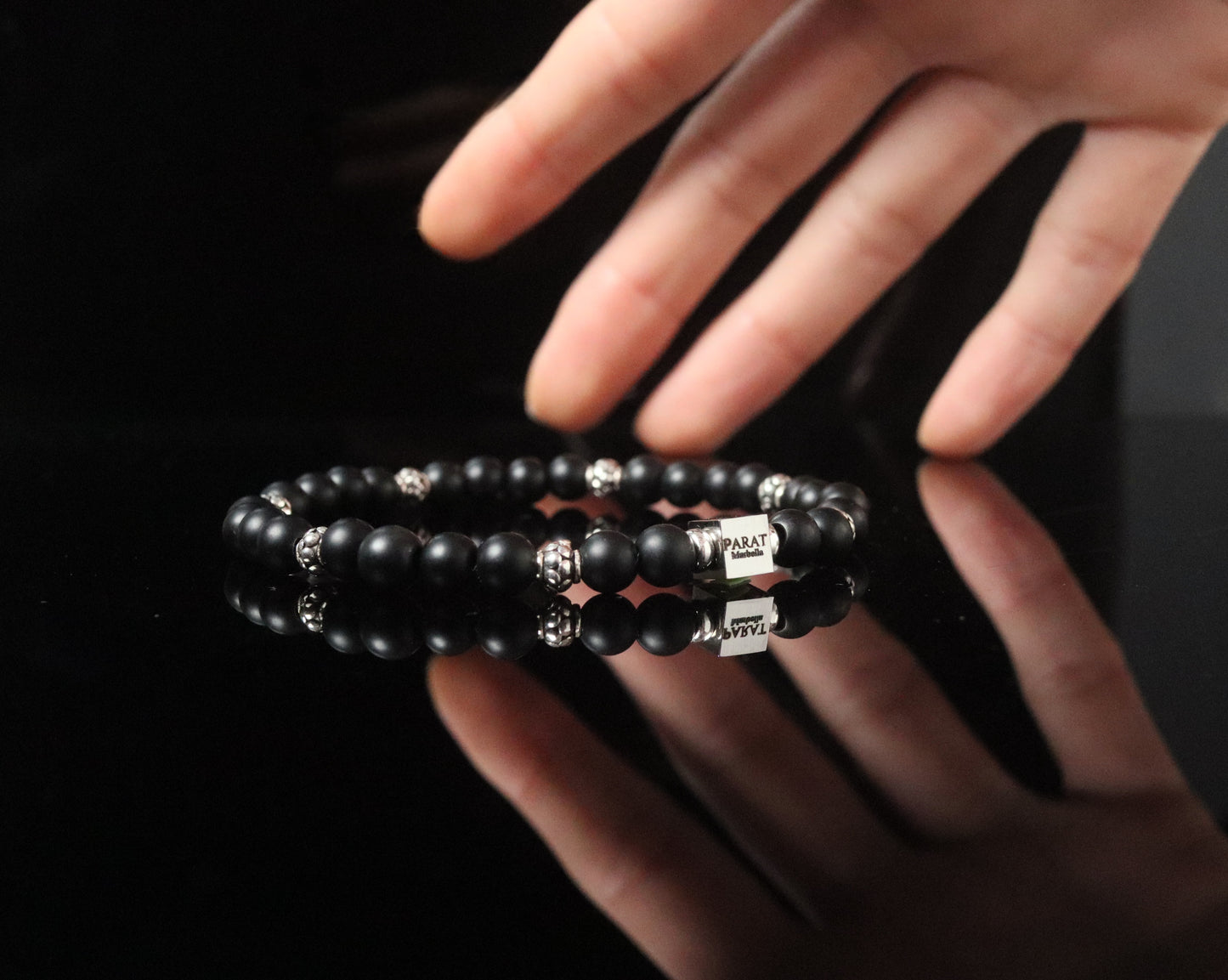 Artistic Frosted Onyx bracelet in hand - matte black silver masculine jewelry