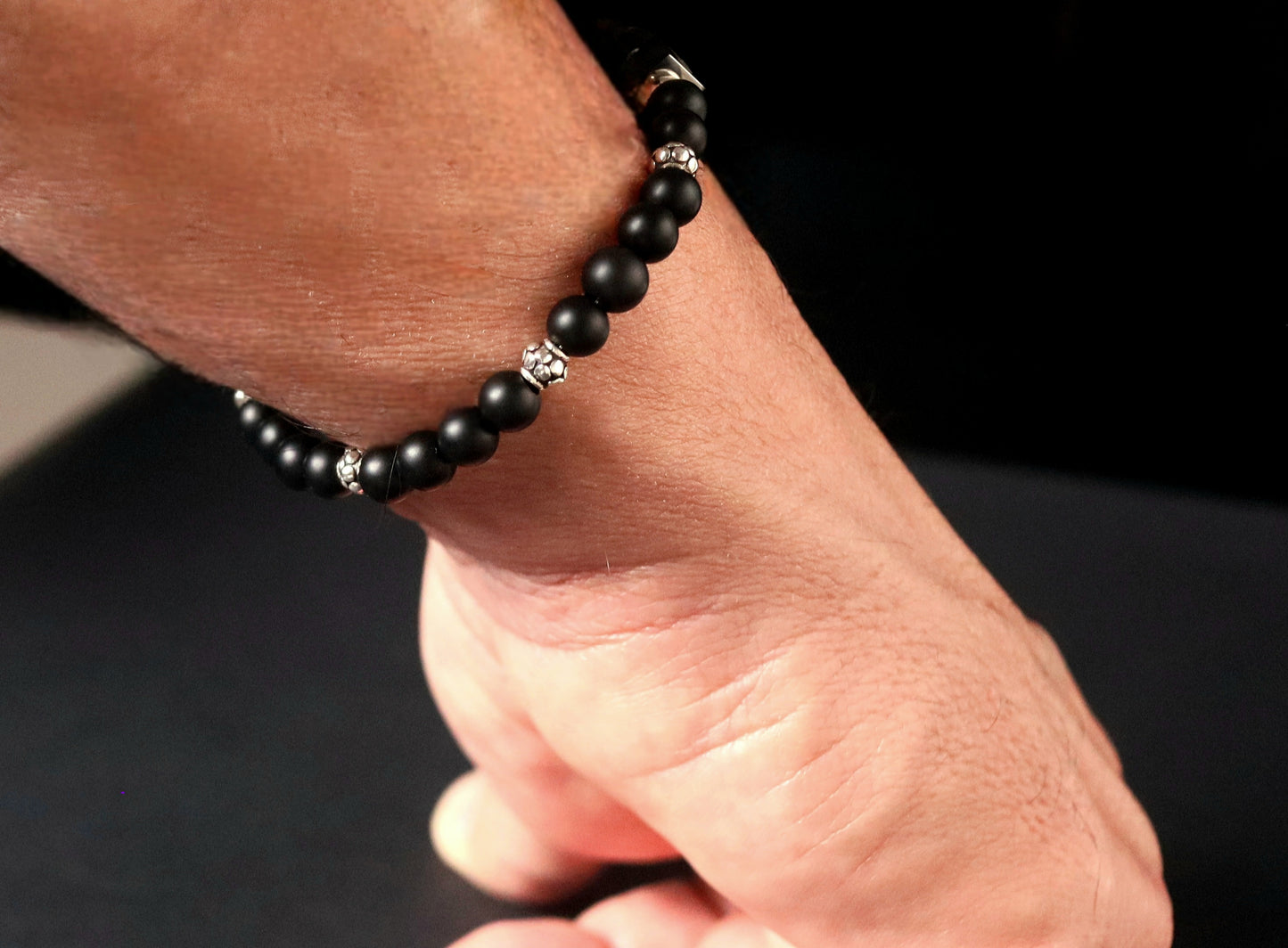 Silver Frosted Onyx bracelet lifestyle on wrist - matte black gemstone skull spacers