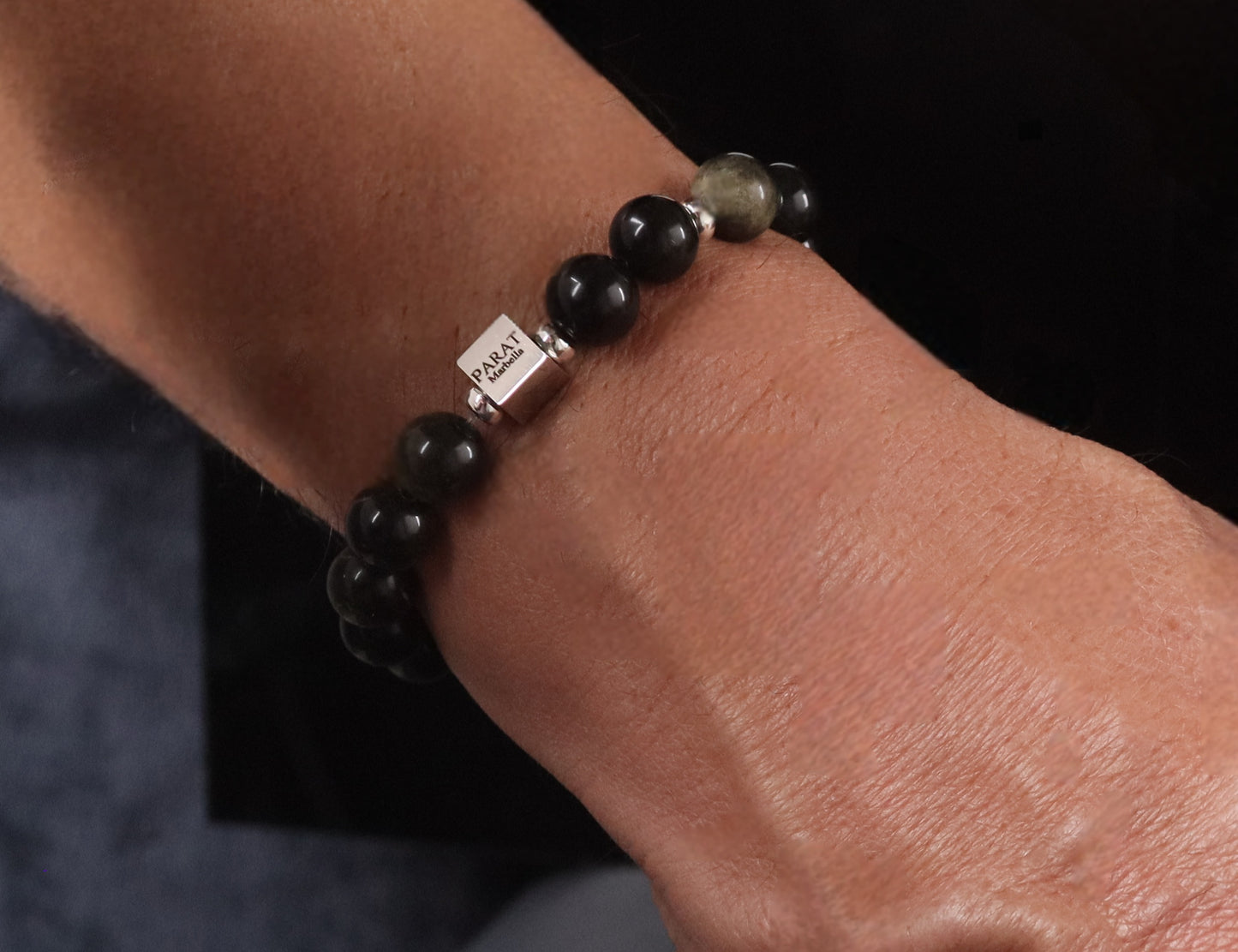 Golden Sheen Obsidian bracelet worn on wrist - lifestyle bold black gemstone jewelry men