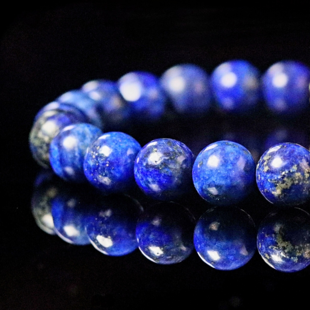 Close-up of premium Lapis Lazuli beads with natural pyrite inclusions