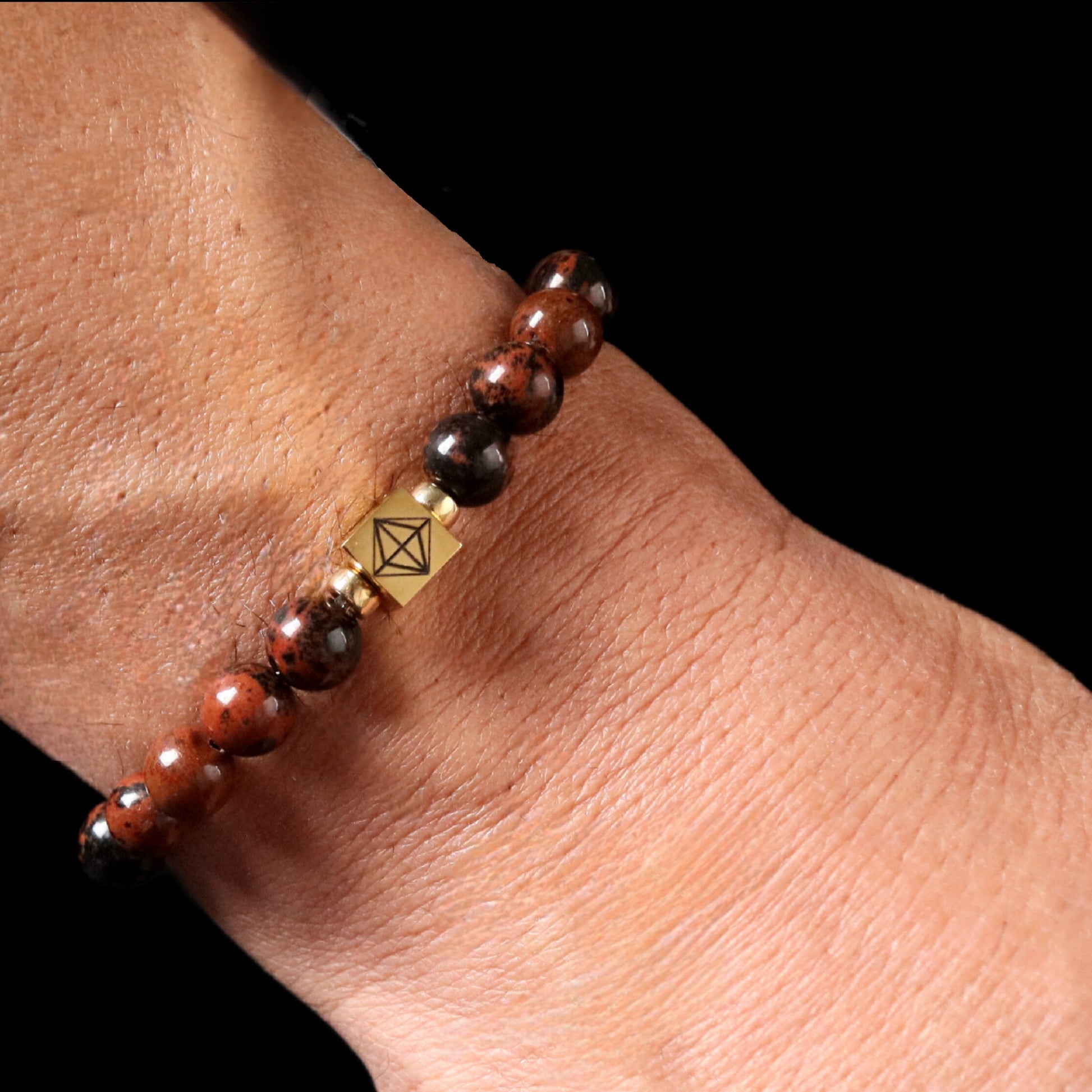 Mahogany Obsidian bracelet worn on wrist - lifestyle earth tone gemstone jewelry men