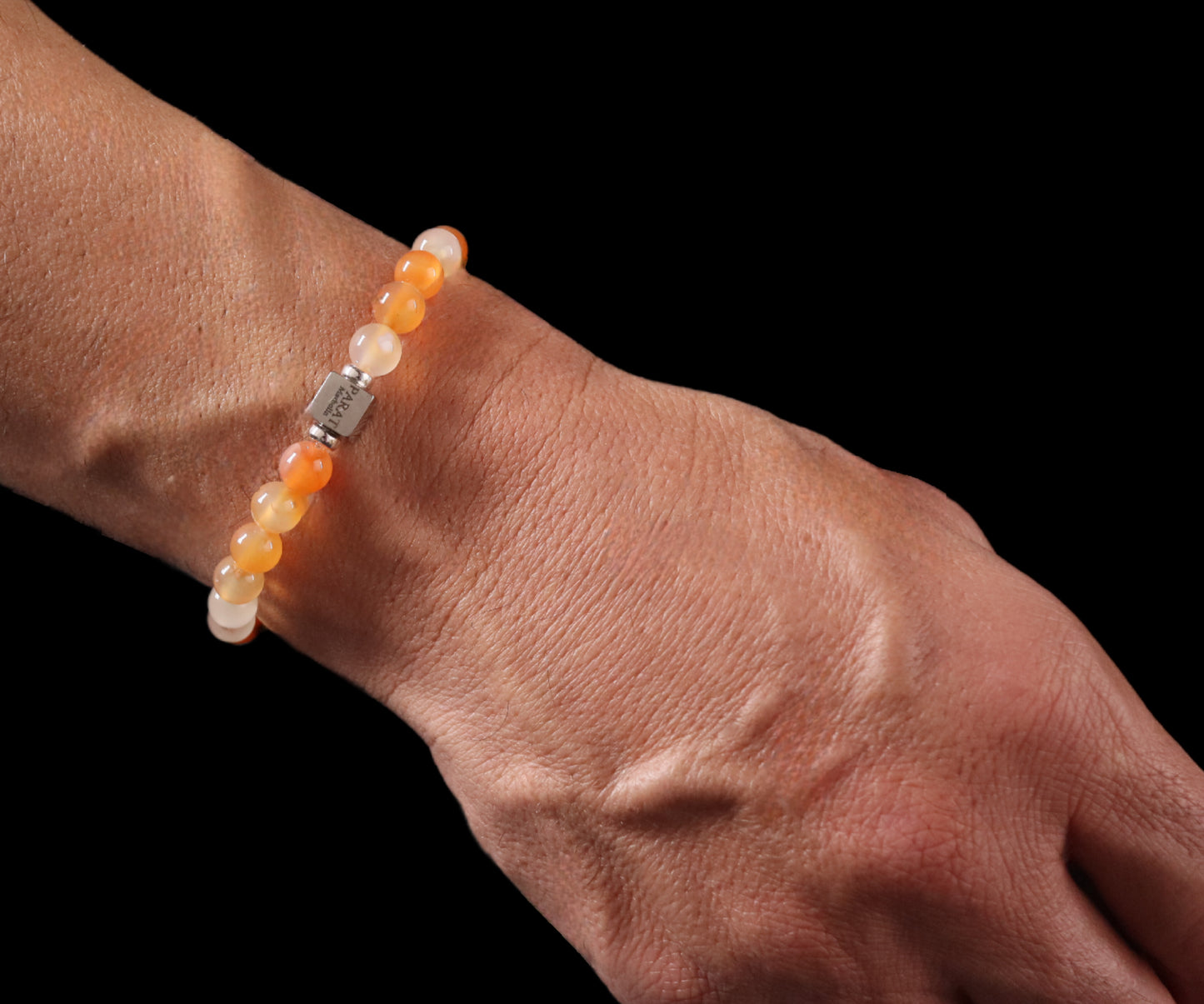 Peach Agate bracelet worn on wrist - lifestyle elegant pastel gemstone jewelry men