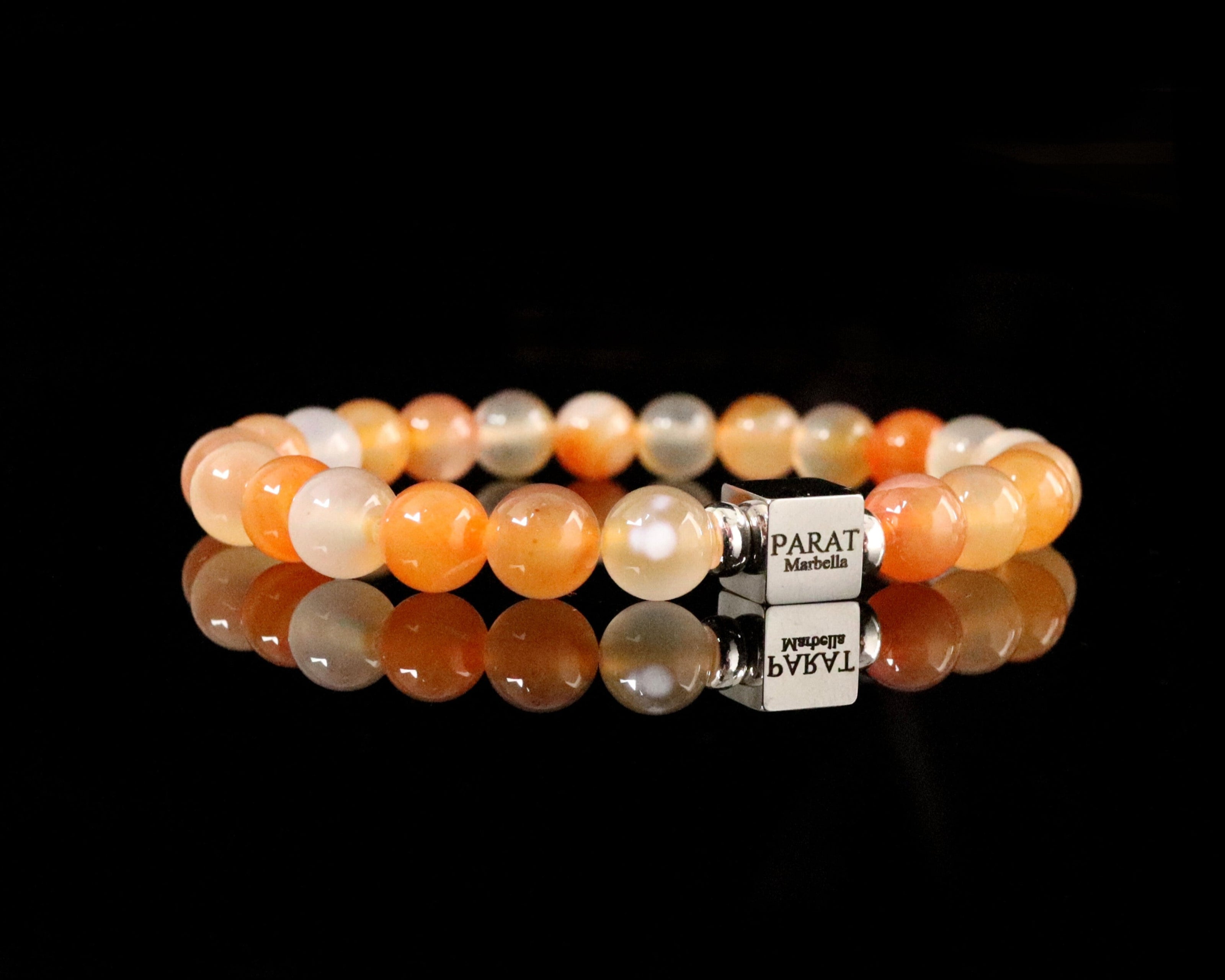 Beaded peach agate gemstone men bracelet with a steel cube logo Parat Marbella on a black background