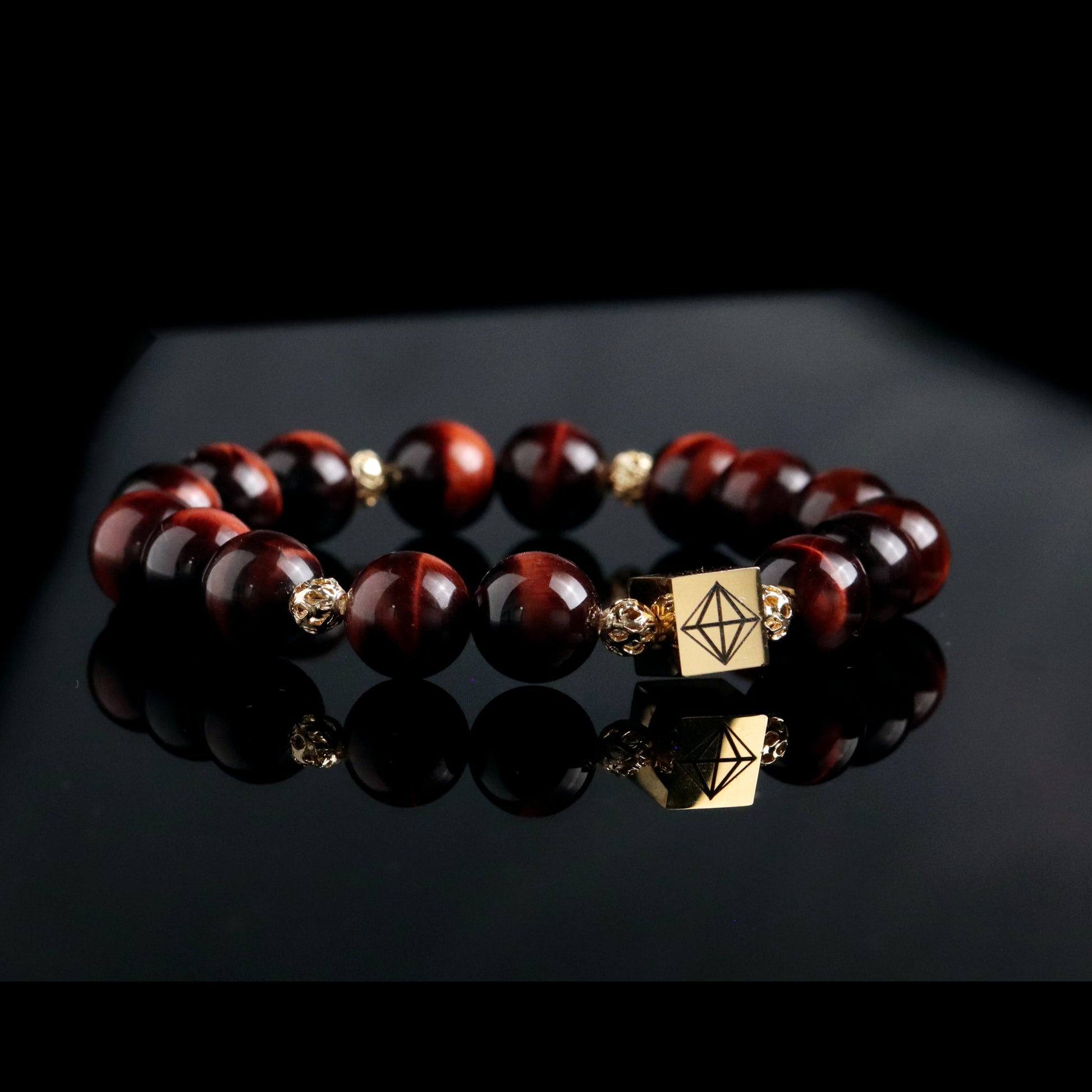 Beaded red tiger eye men bracelet with gold accents on a black 