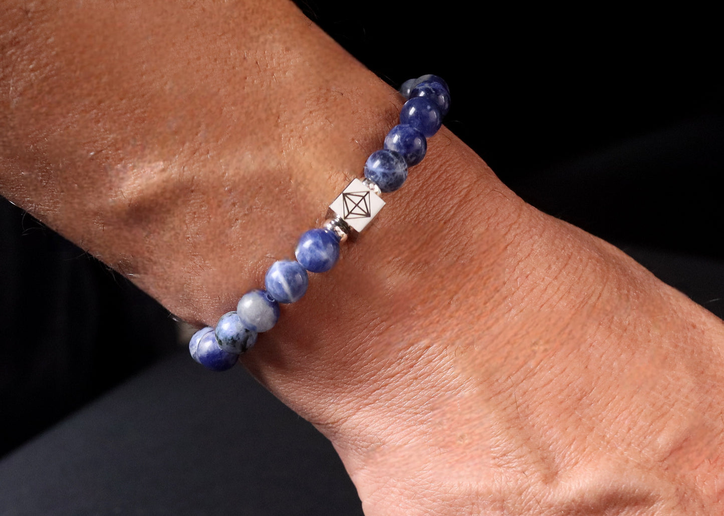 Sodalite bracelet worn on wrist - lifestyle royal blue gemstone jewelry men