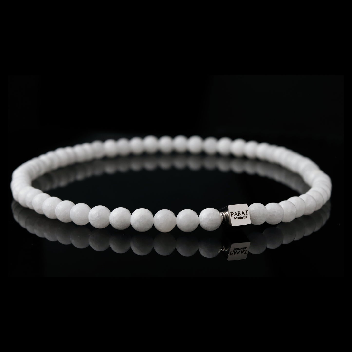 White jade beaded necklace with a brand logo Parat Marbella on a black background